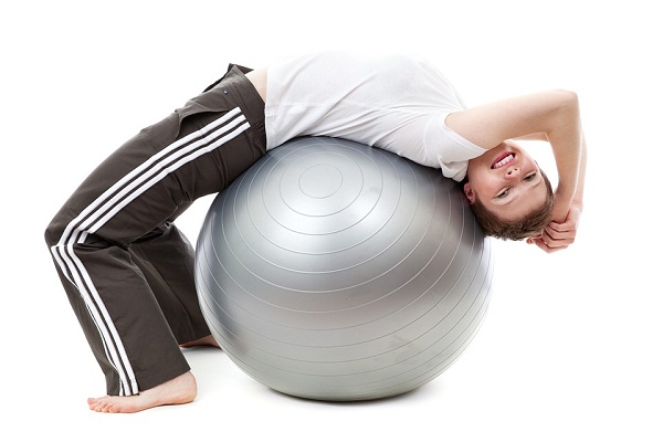 Lie with your back on a Swiss ball